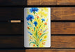 a painting of blue flowers on a wooden bench