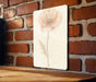 a picture of a flower on a brick wall