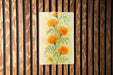 a painting of yellow flowers on a wooden wall