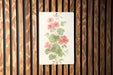 a picture of a flower on a wooden wall
