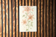 a painting of pink flowers on a wooden wall