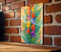 a painting of flowers on a brick wall