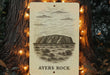 a picture of ayes rock on a tree with a string of lights