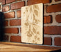 a picture hanging on a brick wall next to a wooden table