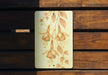 a piece of wood with a painting of flowers on it