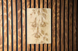 a piece of art hanging on a wooden wall