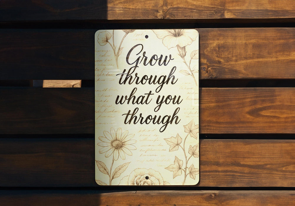 a sign that says grow through what you through