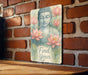 a picture of a buddha statue on a brick wall