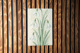 a painting of a flower on a wooden wall