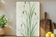 a painting of flowers on a shelf next to lemons