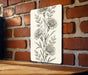 a picture of a flower on a brick wall