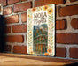 a sign on a brick wall that says nola nights