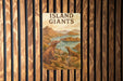 a book about island giants on a wooden wall