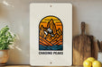 a picture of a mountain range with the words chasing peaks