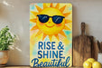 a painting of a sun with sunglasses on a shelf