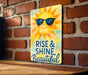 a sign that says rise and shine beautiful on a brick wall