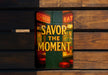 a sign that says savor the moment on a wooden bench