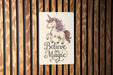 a wooden wall with a sign that says believe in magic