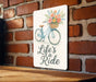 a sign on a brick wall that says life's a ride