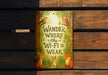 a sign on a wooden bench that says wander where the wi - fi is weak