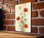 a painting of flowers on a brick wall