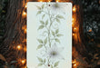 a picture hanging on a tree with lights around it