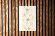 a picture of a flower on a wooden wall