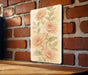 a painting of flowers on a brick wall
