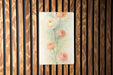 a picture of some flowers on a wooden wall