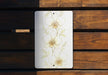 a picture of a white flower on a wooden bench