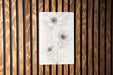 a drawing of three flowers on a wooden wall