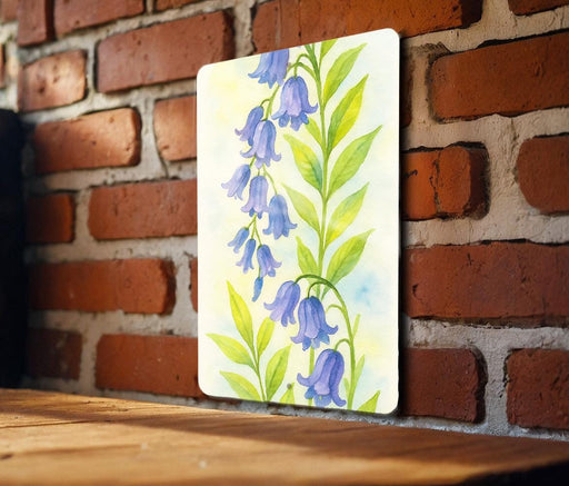 a painting of purple flowers on a brick wall