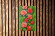 a painting of pink flowers on a wooden wall