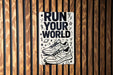 a sign on a wooden wall that says run your world