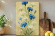 a painting of blue flowers on a yellow background