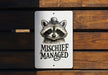 a sign on a wooden bench that says mischife managed