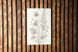 a picture of flowers on a wooden wall