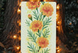 a painting of orange flowers is hanging on a tree