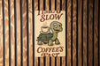 a sign on a wall that says time's slow coffee's fast