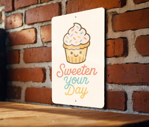 a sign that says sweeten your day on a brick wall