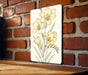 a painting of yellow flowers on a brick wall