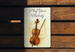 a picture of a violin on a wooden bench