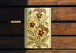 a close up of a wooden bench with flowers painted on it