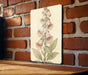 a picture of a flower on a brick wall