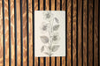 a picture of a flower on a wooden wall