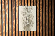a picture of some flowers on a wooden wall