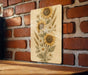 a picture of sunflowers on a brick wall