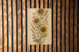 a painting of sunflowers on a wooden wall