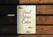 a sign that says find your calm on a wooden bench