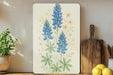 a painting of blue flowers on a white background